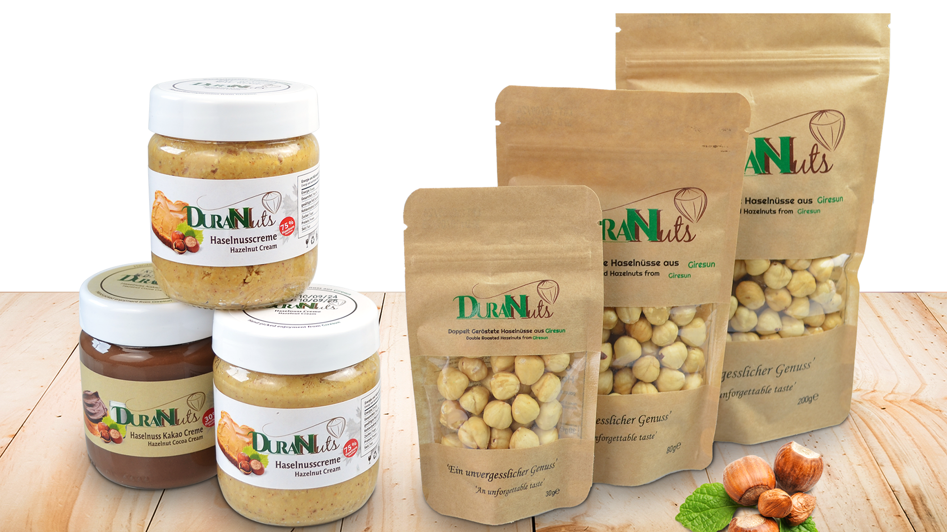 Assorted DuranNuts hazelnut cremes and snacks in jars and pouches on a wooden table.