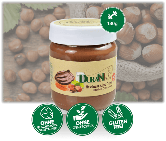 Haselnuss Kakao Creme 180g in a jar, featuring gluten-free, no additives, and non-GMO labels, with hazelnuts in the background.